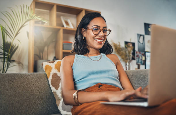 Female business owner typing at laptop