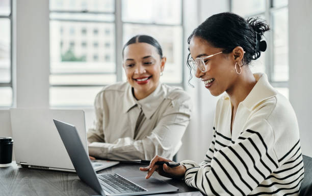 Business women, laptop and and happy team in office.