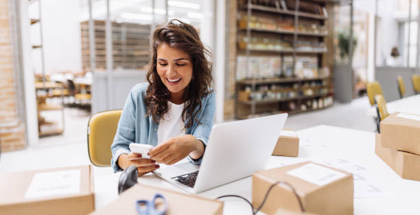 Female business owner creating a social media caption on her phone